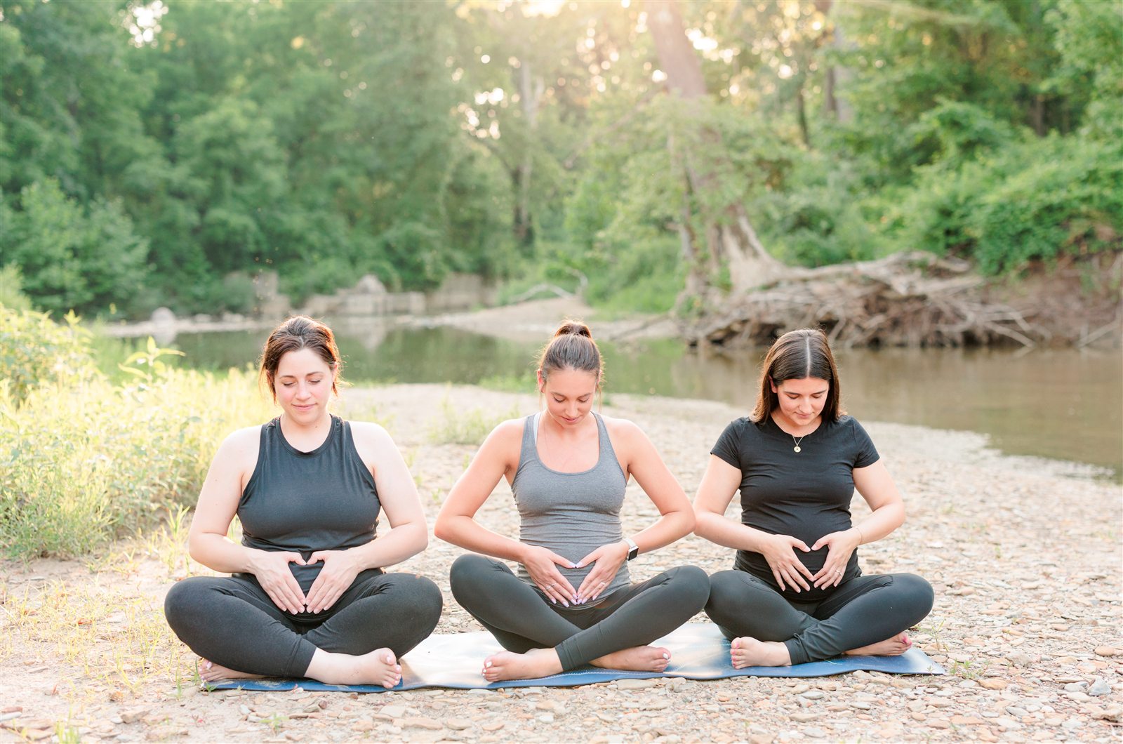 Pregnant women practicing breath work outdoors