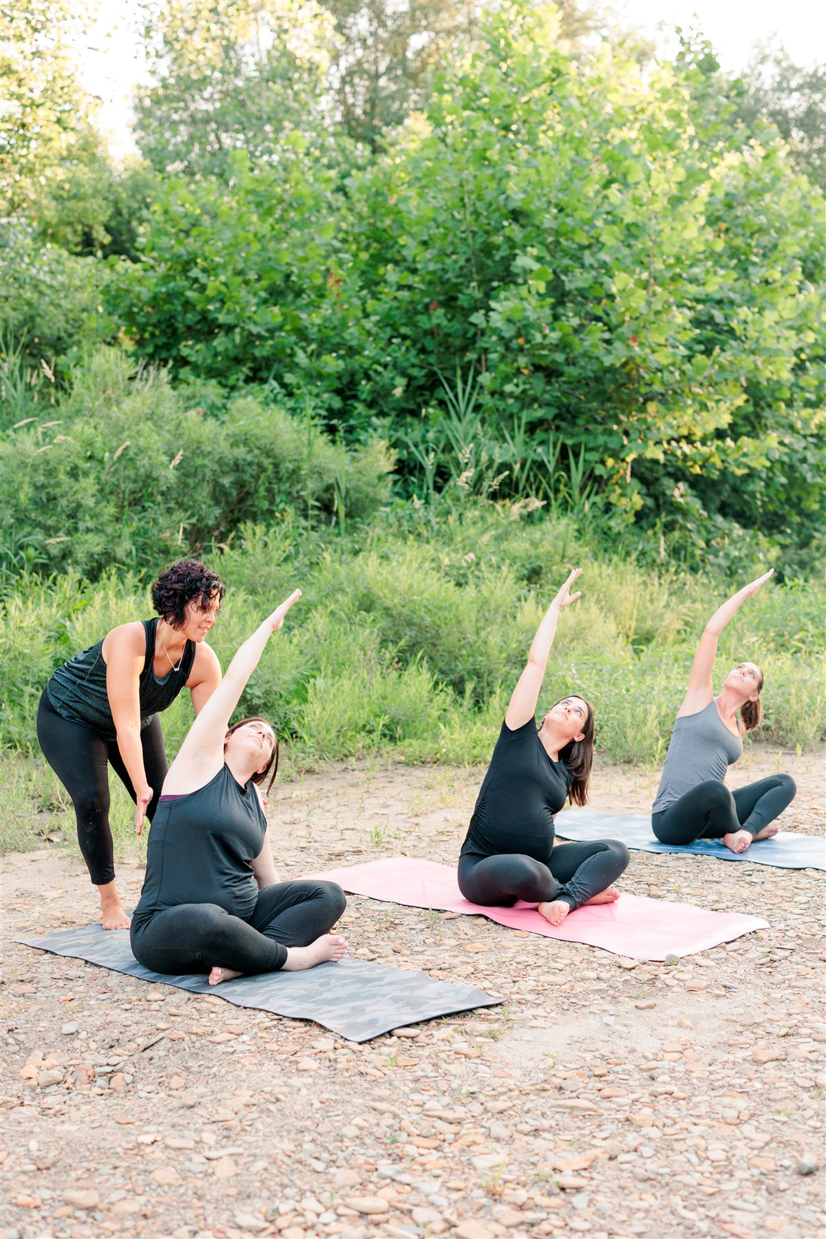 Lisa guiding a prenatal yoga class outdoors